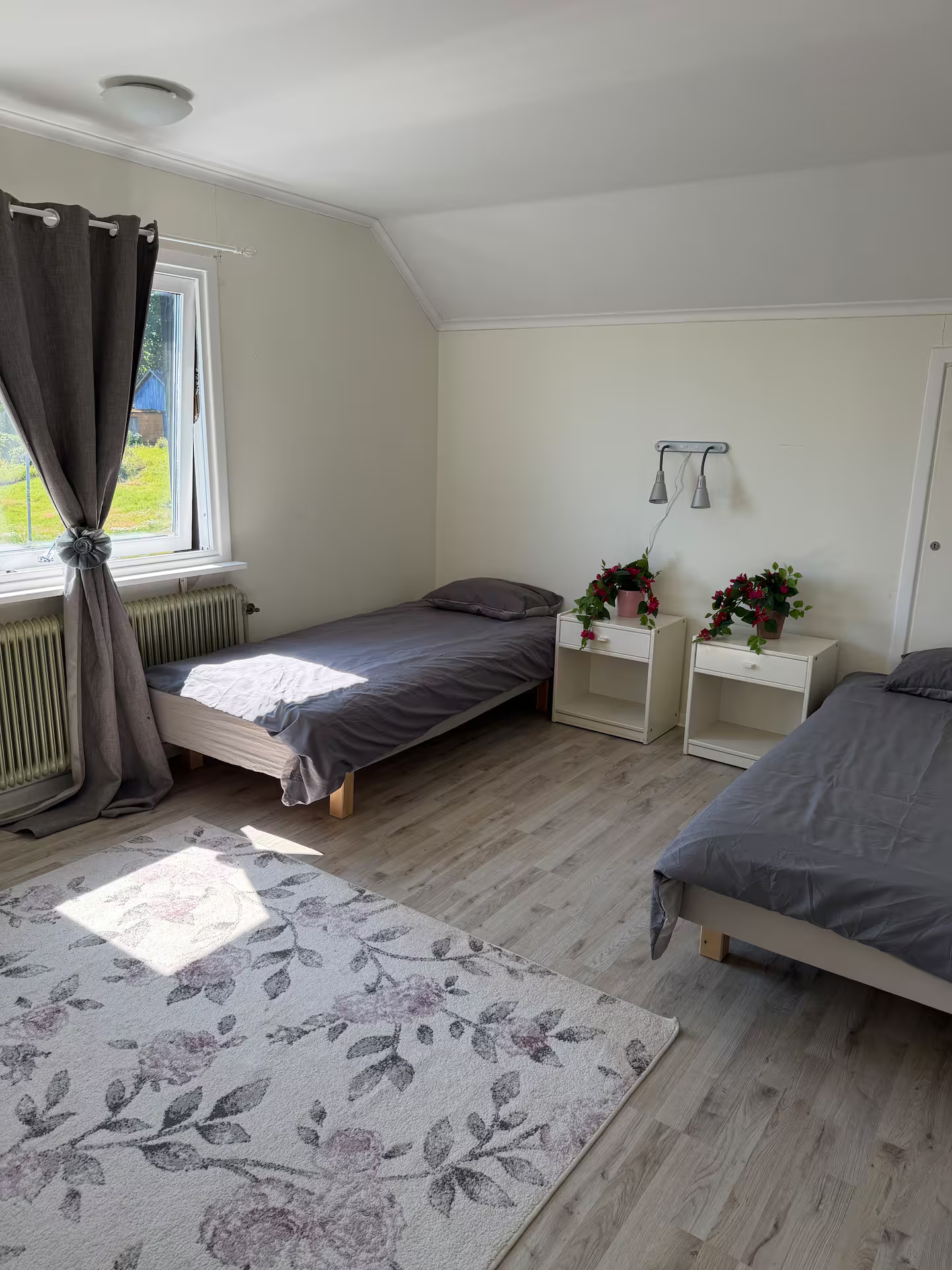 Second twin bedroom with a floral rug